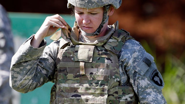 Spec. Sarah Sutphin adjusts her new body armor while training on firing range Tuesday in Fort Campbell, Ky.  