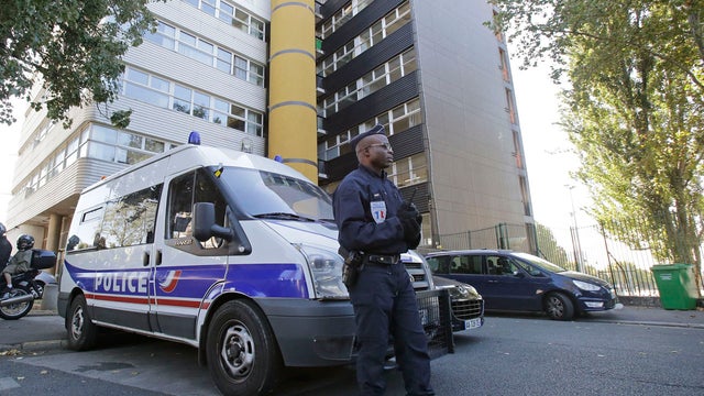 A French policeman stands guard outside the headquarters of the satirical weekly Charlie Hebdo in Paris 