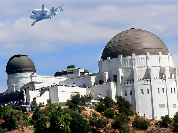LOS ANGELES, CA - SEPTEMBER 21: The space shuttle Endeavour, on top of NASA's Shuttle Carrier Aircraft or SCA, flies over the Griffith Park Obervatory on September 21, 2012 in Los Angeles, California. The space shuttle Endeavour did a 4-1/2 hour tour over 