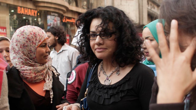 Mona Eltahawy, a prominent Egyptian-born U.S. columnist, center, marches in downtown Cairo 
