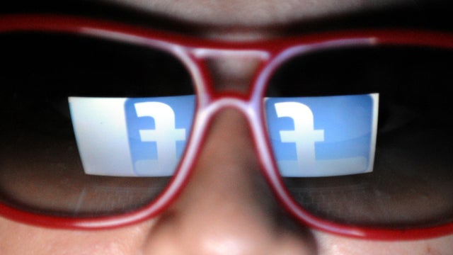 A logo of social networking website Facebook is reflected on the sunglasses of a student on May 14, 2012, in Manila, Philippines. 