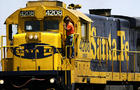 A worker rides a Burlington Northern Santa Fe EMD GP50 diesel train engine on May 11, 2004, in Los Angeles. 
