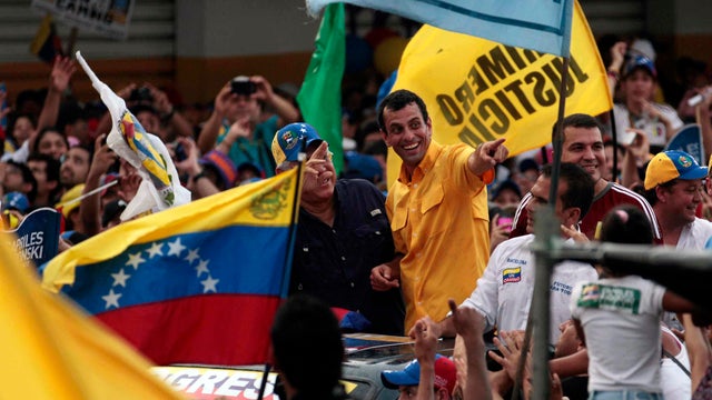 Opposition presidential candidate Henrique Capriles, center, who will run against Venezuelan President Hugo Chavez in the presidential election Oct. 7, attends a campaign rally in Barcelona, Venezuela, Tuesday, Oct. 2, 2012.  