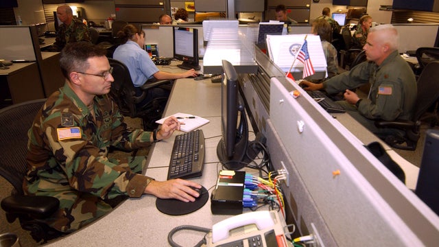August 2004 file photo shows unidentified analysts at Combined Intelligence and Fusion Center for NORAD/Northcom in Colorado Springs, Colo. 