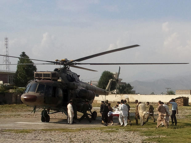 A wounded Pakistani girl, Malala Yousufzai, is moved to a helicopter. 