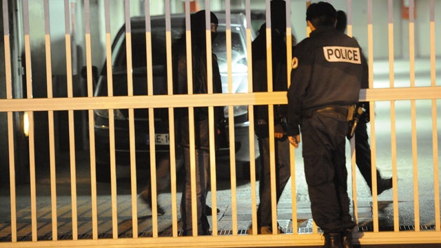 Policemen take part in a search of lock-up garages outside Paris 