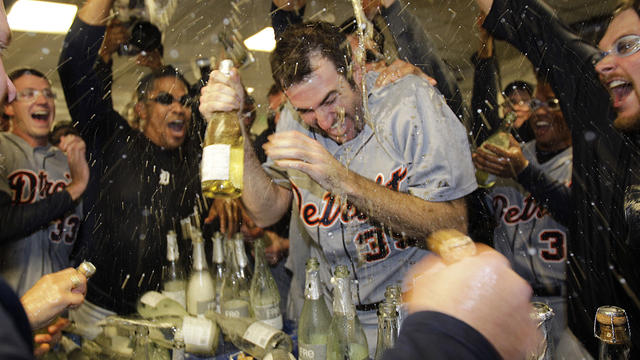 Detroit Tigers' Justin Verlander being  drenched with sparkling wine by teammates after beating Oakland A's 