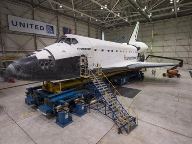 Retired space shuttle Endeavour in LAX hangar being prepared for 2 mph trip to final display spot, the California Science Center 