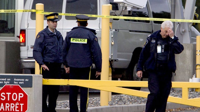 Police investigate a van at the scene of a shooting at the Blaine, Wash./Surrey, British Columbia border crossing Tuesday, Oct. 16, 2012. 
