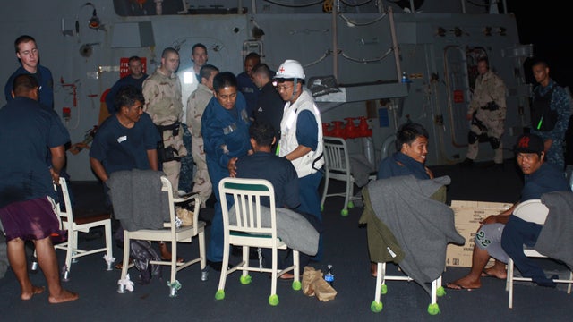 Rescued fishermen with sailors on board USS McCampbell Wednesday 