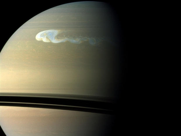 An image of Saturn taken in December 2010 by the Cassini spacecraft shows a storm with a latitudinal and longitudinal extent of 10,000 km and 17,000 km, respectively. 