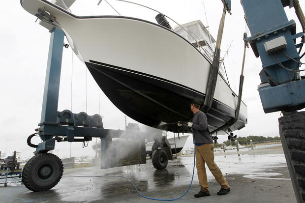 A marina worker rinses off a fishing boat pulled out from the Indian River at the Indian River Marina in Delaware, Md. 