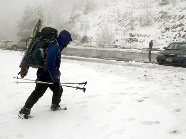 Backpacker Will Overman of Virginia Beach, Va., heads to his car Monday, Oct. 29, 2012, in the Great Smoky Mountains National Park, near Gatlinburg, Tenn. About 50 backpackers took shelter in the park during Sunday night's snowfall. Rangers expect more sn 