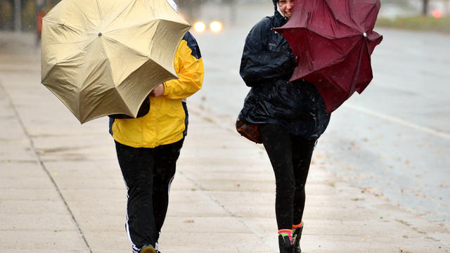 Two women try to hold onto their umbrellas in a wind-soaked rainfall as the superstorm Sandy approaches Oct. 29, 2012, in Philadelphia. 