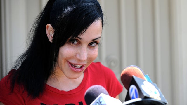 "Octomom" Nadya Suleman poses for photographers in front of her home in La Habra, Calif., May 19, 2010. 