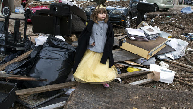 Lisa Kravchenko stands among flood debris in her princess Halloween costume Oct. 31, 2012, in the Staten Island borough of New York. 