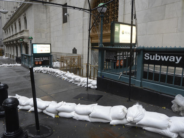 Sandbags are piled in front of the New York Stock Exchange and a close-by subway entrance October 29, 2012 as New Yorkers prepare for Hurricane Sandy 