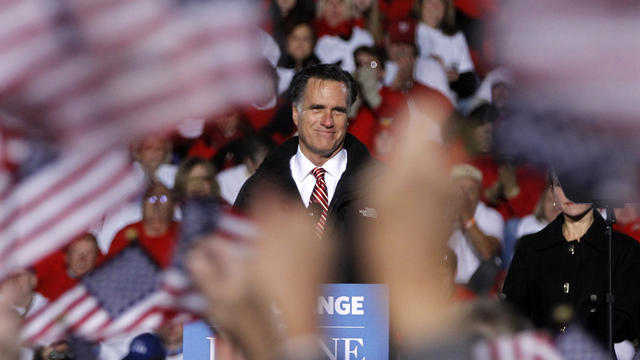Supporters wave American flags as Republican presidential candidate, former Massachusetts Gov. Mitt Romney speaks during a campaign event in West Chester, Ohio, Friday, Nov. 2, 2012.  