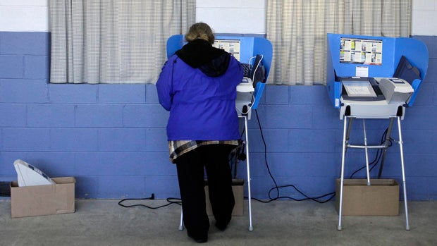 A voter uses an electronic voting machine on Nov. 6, 2012, in Portage, Ohio. 