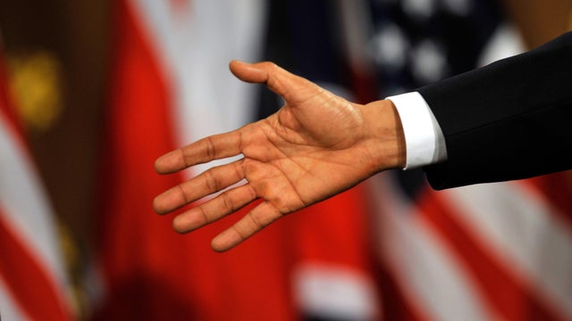 An American leader offers his hand on April 1, 2009, at the Foreign and Commonwealth Office in London, England. 