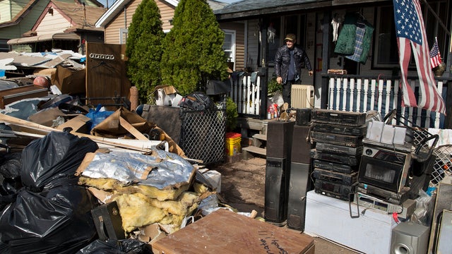 Salvatore Conte, 65, looks out at the debris removed from his home that was severely damaged by superstorm Sandy Nov. 5, 2012, in New York. Conte, a Vietnam veteran, has lived in this house since 1995. 