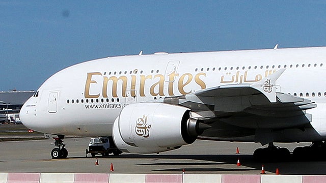 Emirates A380 that suffered engine damage sits on the edge of the tarmac at Sydney international airport 