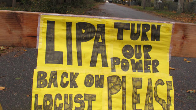 A plea to the Long Island Power Authority for electricity to be restored is posted on a barrier Wednesday, Oct. 31, 2012, in Mastic Beach, N.Y. The south shore Long Island community was among the hardest hit by the storm that pounded the northeast earlier 