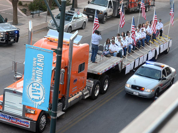 A flatbed truck carries wounded veterans and their families during a parade before it was struck by a train Thursday, Nov. 15, 2012 in Midland, Texas. 