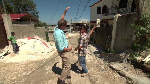 Sean Penn motions how high the rubble was before the cleanup 