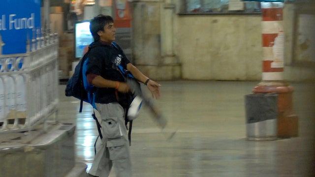 Nov. 26, 2008 file photo shows Ajmal Kasab walking at Chatrapathi Sivaji Terminal railway station in Mumbai, India 