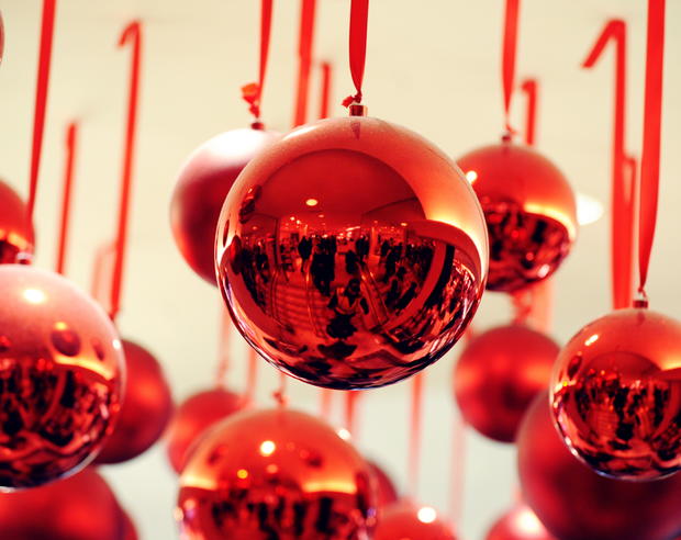 Shoppers are reflected in Christmas ball 