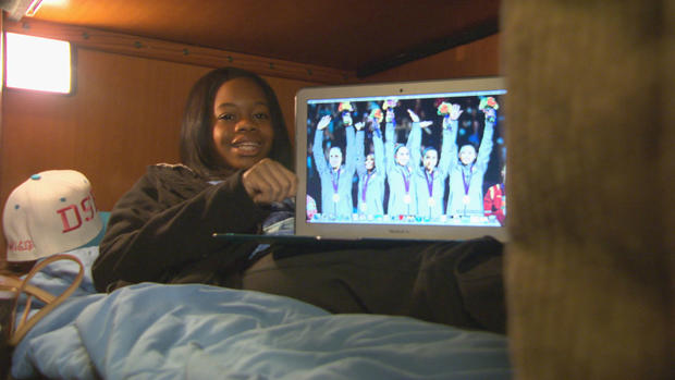 From her bunk, Douglas shows her screensaver - a photo of the "Fierce Five," her Team USA teammates 