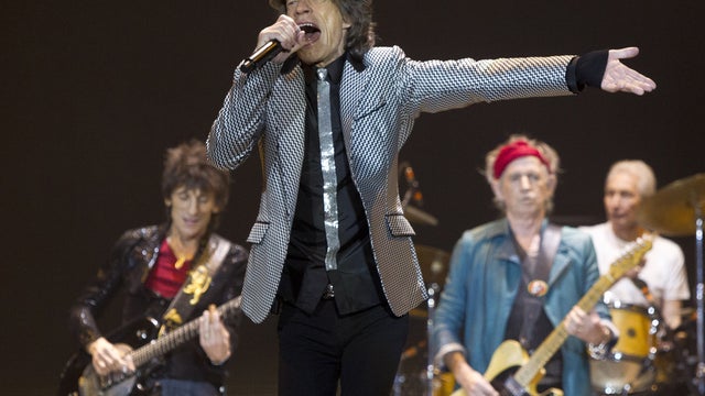 Mick Jagger, front center, Ronnie Wood, left, with Keith Richards and Charlie Watts, right, of The Rolling Stones perform at the O2 arena in east London, Sunday, Nov. 25, 2012.  