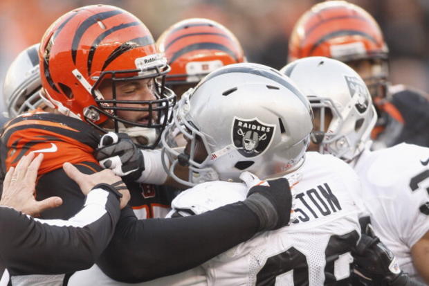 Andrew Whitworth #77 of the Cincinnati Bengals and Lamaar Houston #99 of the Oakland Raiders 