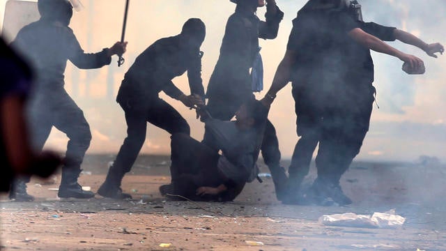 Egyptian security forces arrest a protester during clashes near Tahrir Square in Cairo Nov. 27, 2012. 