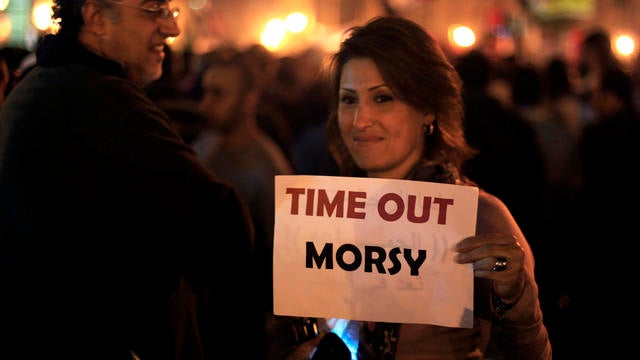 A protester holds a placard against Egyptian President Mohammed Morsi at an opposition rally in Tahrir Square in Cairo Nov. 27, 2012. 