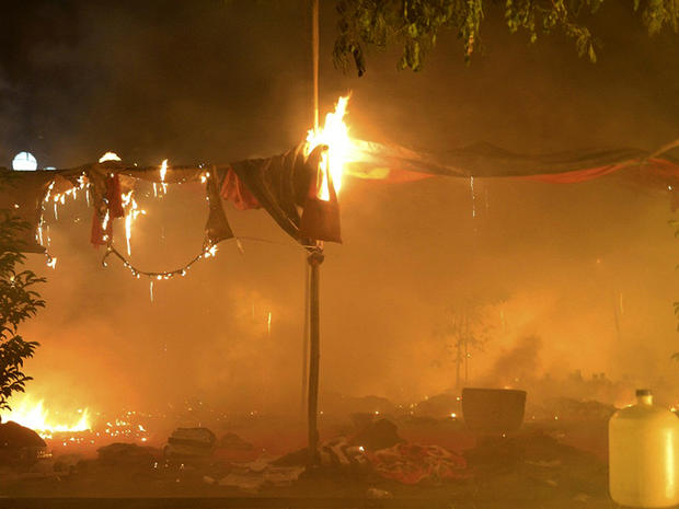 An encampment occupied by protesters burns at the Letpadaung mine following a crackdown by security forces near the town of Monywa, Burma, early in the morning Nov. 29, 2012, in this picture released by Eleven Media Group. 