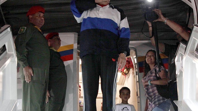 Venezuelan President Hugo Chavez blows a goodbye kiss prior to boarding his plane at Simon Bolivar International Airport in Maiquetia, Venezuela, Dec. 10, 2012, in this picture released by Miraflores Press Office. 