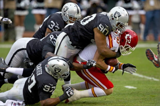 Desmond Bryant #90 of the Oakland Raiders and Dexter McCluster #22 of the Kansas City Chiefs 