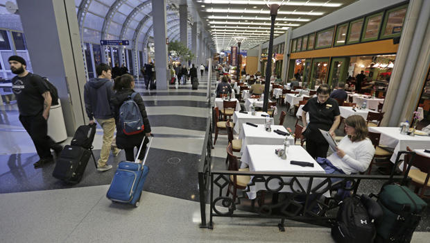 A diner at Wolfgang Puck Cafe in  O'Hare International Airport in Chicago sits in a sidewalk cafe setting in Terminal 3. 