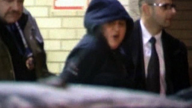 Erika Menendez, center, is led away by police Dec. 29, 2012, in New York. 