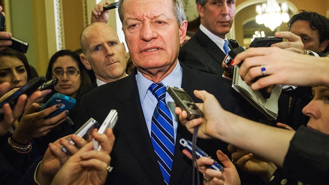 Sen. Max Baucus, D-Mont., talks with reporters in the halls of the U.S. Senate late Dec. 31, 2012, in Washington. 