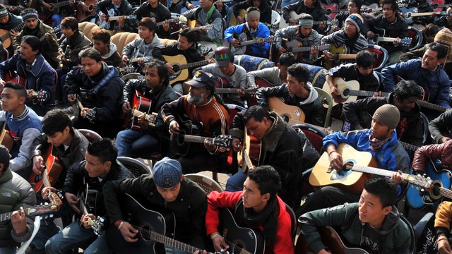 Some 600 guitarists play John Lennon's "Imagine" in a memorial tribute to a 23-year-old Indian gang rape victim during a mass guitar ensemble in Darjeeling, India, Jan. 3, 2013. 