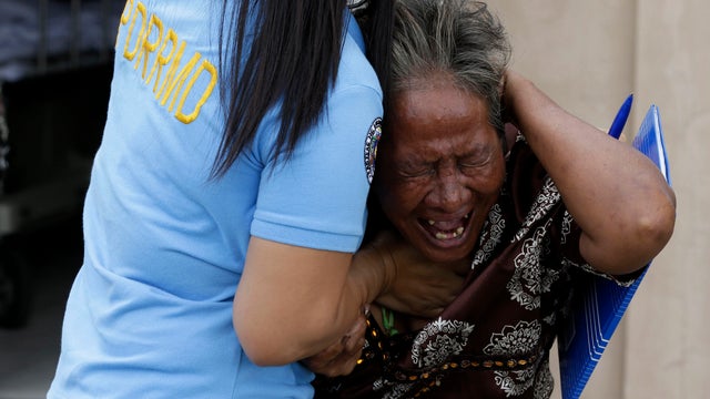 Aniolina Caimol, 63, the grandmother of shooting victim Micaela Caimol, 7, cries after viewing her granddaughter inside the morgue of a private hospital in Kawit township, Philippines, Jan. 4, 2013. 