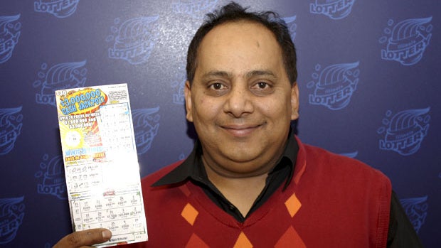 This undated photo provided by the Illinois Lottery shows Urooj Khan, 46, of Chicago's West Rogers Park neighborhood, posing with a winning lottery ticket. 