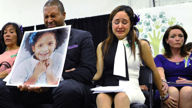 Jimmy Greene, foreground left, Nelba Marquez-Greene, center, parents of Sandy Hook Elementary School shooting victim Ana Marquez-Greene, and Nicole Hockley, right, mother of victim Dylan Hockley, react during a news conference at Edmond Town Hall in Newto 