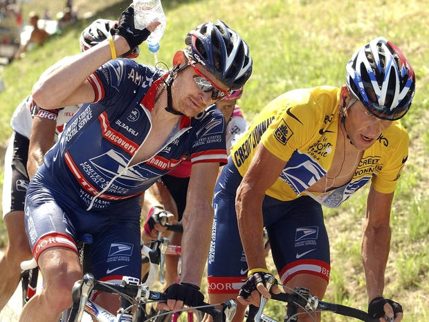 In this July 22, 2004, file photo, Lance Armstrong, right, climbs the ascent of the La Croix Fry pass as teammate Floyd Landis, left, pours water over his neck during the 17th stage of the Tour de France cycling race between Bourg-d'Oisans and Le Grand Bo 