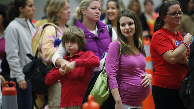 A pregnant waits to receive the flu shot 