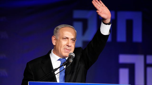 Israeli Prime Minister Benjamin Netanyahu waves to supporters at his election campaign headquarters 