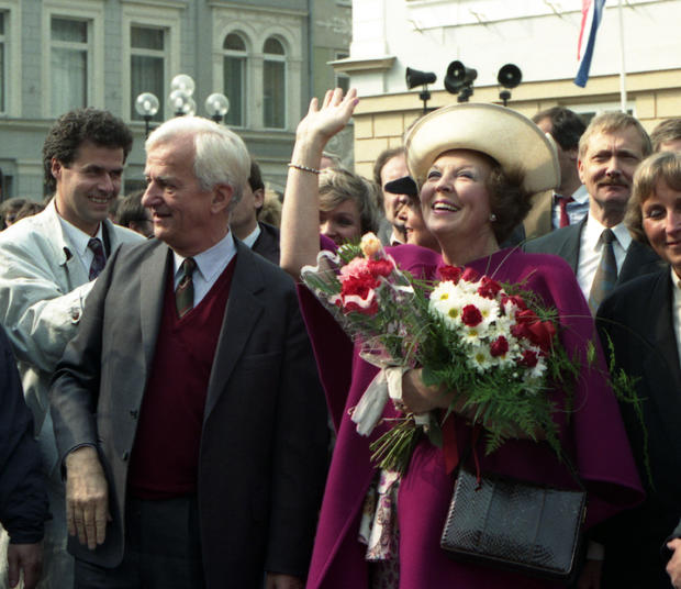 Queen Beatrix of the Netherlands, flashes a broad smile as she stands next to German President Richard von Weizsaecker, waving to citizens who came to meet her in Guestrow, former east Germany, Friday April 26, 1991.  